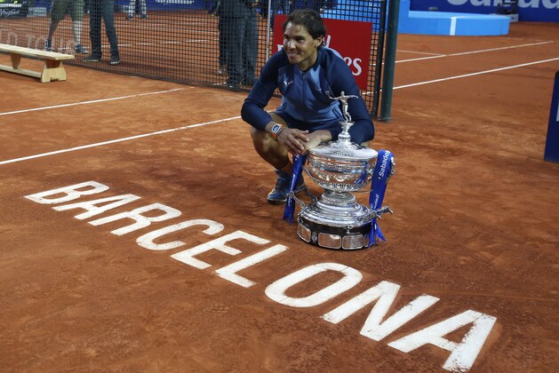 Spain's Rafael Nadal poses for a photo with the trophy after winning the Barcelona Open tennis tournament in Barcelona, Spain, Sunday, April 24, 2016. Spain's Rafael Nadal defeated Japan’s Kei Nishikori 6-4 and 7-5, in the final. (AP Photo/Manu Fernandez)