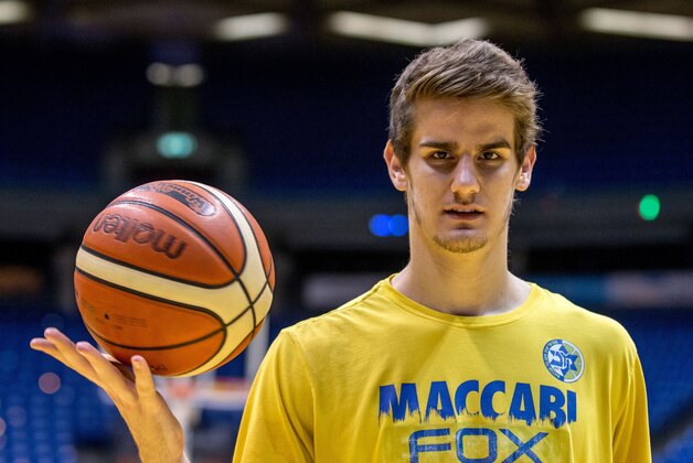 Dragan Bender, a professional Croatian basketball player currently playing for Maccabi Tel Aviv in the Israeli Basketball Super League poses for a photo after a training session at the Menora Mivtachim Arena in Tel Aviv on March 16, 2016.
Bender's name is not yet well known beyond hardcore basketball fans, but that may soon change. Bender is expected to be highly sought after by US professional basketball teams in the coming months.
 / AFP / JACK GUEZ        (Photo credit should read JACK GUEZ/AFP/Getty Images)