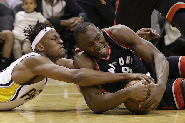 Indiana Pacers' Myles Turner (33) and Toronto Raptors' Bismack Biyombo (8) battle for a loose ball during the second half of Game 4 of an NBA first-round playoff basketball series Saturday, April 23, 2016, in Indianapolis. Indiana won 100-83. (AP Photo/Darron Cummings)