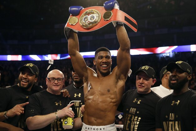 British boxer Anthony Joshua celebrates after winning the IBF heavyweight title bout between US boxer Charles Martin and British boxer Anthony Joshua at the O2 Arena in London, Saturday, April 9, 2016.(AP Photo/Matt Dunham)