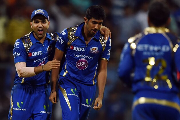 Mumbai Indians captain Rohit Sharma (L) and Jasprit Bumrah (R) celebrate the wicket of Gujarat Lions Dwayne Bravo during the 2016 Indian Premier League(IPL) Twenty20 cricket match between Gujarat Lions and Mumbai Indians at the Wankhede Stadium in Mumbai on April 16, 2016. / AFP / INDRANIL MUKHERJEE / ----IMAGE RESTRICTED TO EDITORIAL USE - STRICTLY NO COMMERCIAL USE----- / GETTYOUT        (Photo credit should read INDRANIL MUKHERJEE/AFP/Getty Images)