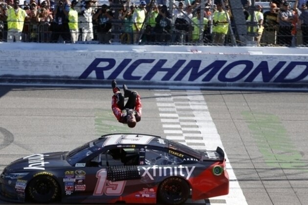Carl Edwards does a back flip off his car after winning the Sprint Cup auto race at Richmond International Raceway in Richmond, Va., Sunday, April 24, 2016. (AP Photo/Chet Strange)