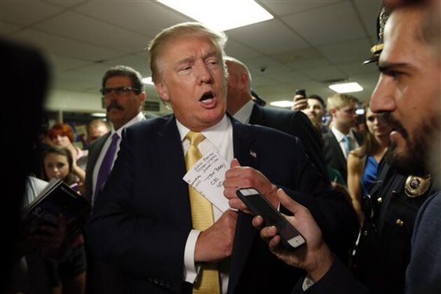 FILE - In this Sept. 17, 2015 file photo, a reference to New England Patriots quarterback Tom Brady is seen on the notes of Republican presidential candidate Donald Trump as he tucks his papers into his jacket as he arrives at a town hall event in Rochester, N.H.  Brady says his comments that he hopes Donald Trump will win the presidency were taken out of context and an example of why he tries to say as little as possible when speaking publicly. (AP Photo/Robert F. Bukaty)
