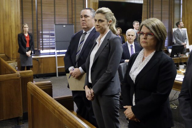 Sportscaster and television host Erin Andrews, center, stands with attorney Scott Carr, second from left, as the jury arrives in the courtroom after reaching a verdict Monday, March 7, 2016, in Nashville, Tenn. A jury awarded Andrews $55 million in her lawsuit against a stalker who bought a hotel room next to her and secretly recorded a nude video, finding that the hotel companies and the stalker shared in the blame. (AP Photo/Mark Humphrey)