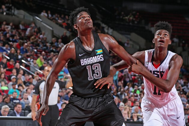 PORTLAND, OR - APRIL 9:  DeAndre Ayton #13 the World Select Team boxes out Jonathan Issac #11 of the USA Junior Select Team during the game on April 9, 2016 at the MODA Center Arena in Portland, Oregon. NOTE TO USER: User expressly acknowledges and agrees that, by downloading and or using this photograph, User is consenting to the terms and conditions of the Getty Images License Agreement. Mandatory Copyright Notice: Copyright 2016 NBAE (Photo by Sam Forencich/NBAE via Getty Images)