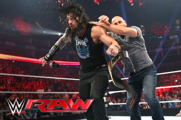 Karl Anderson and Luke Gallows take out Roman Reigns.