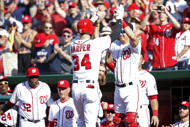 Apr 24, 2016; Washington, DC, USA; Washington Nationals right fielder Bryce Harper (34) celebrated with Nationals catcher Jose Lobaton (59) after hitting a pinch-hit game-tying home run against the Minnesota Twins in the bottom of the ninth inning at Nationals Park. The Nationals won 5-4 in sixteen innings. Mandatory Credit: Geoff Burke-USA TODAY Sports