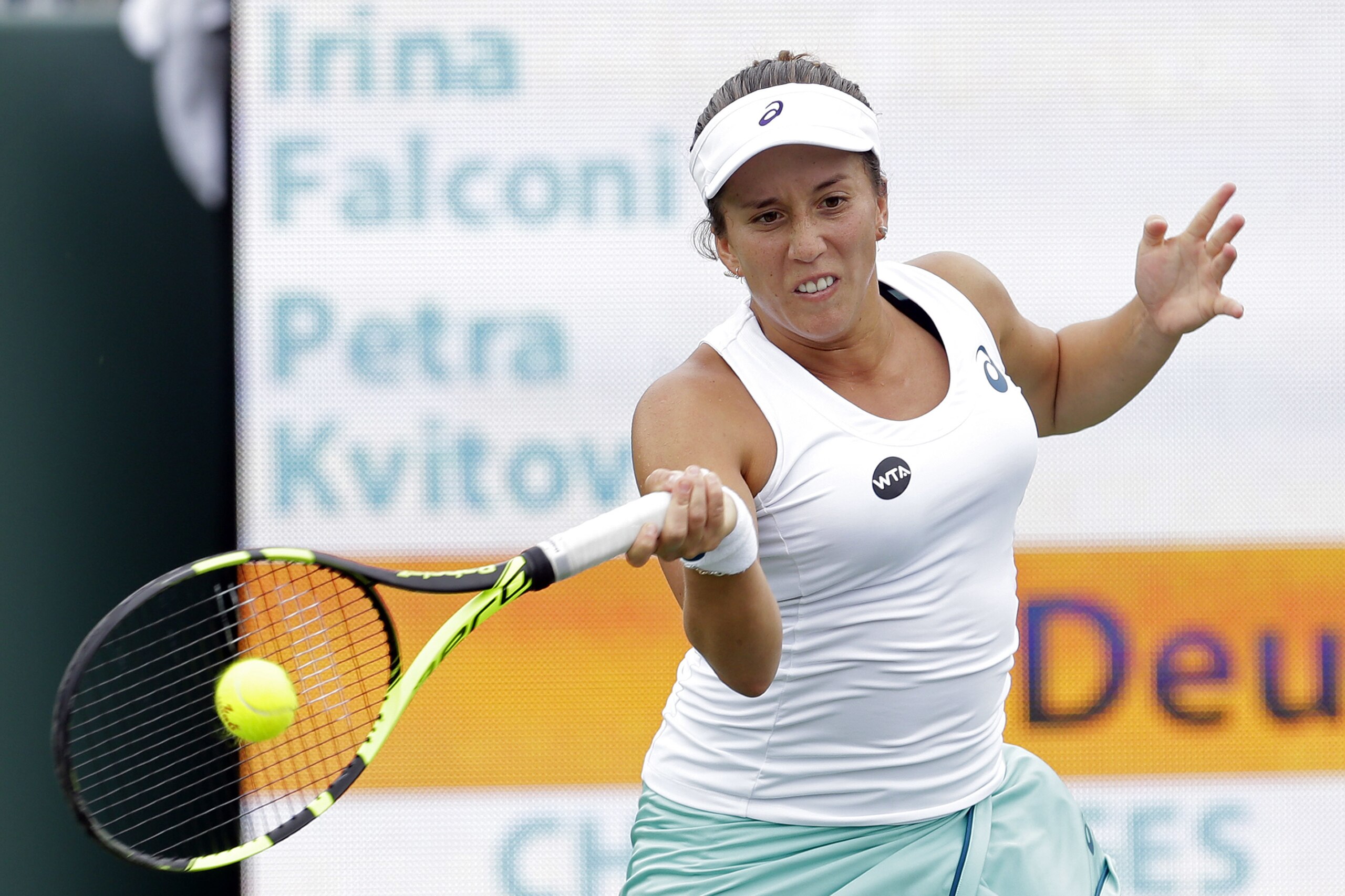 Irina Falconi returns to Petra Kvitova, of the Czech Republic, during a match at the Miami Open tennis tournament in Key Biscayne, Fla., Thursday, March 24, 2016. (AP Photo/Alan Diaz)