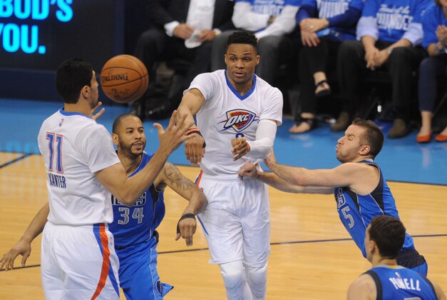 Apr 25, 2016; Oklahoma City, OK, USA; Oklahoma City Thunder guard Russell Westbrook (0) passes the ball between Dallas Mavericks guard Devin Harris (34) and Dallas Mavericks guard J.J. Barea (5) during the second quarter in game five of the first round of the NBA Playoffs at Chesapeake Energy Arena. Mandatory Credit: Mark D. Smith-USA TODAY Sports