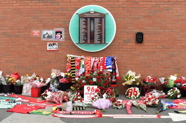 Flowers and football scarves lay in front of the temporary Hillsborough memorial, ahead of a memorial service at Anfield in Liverpool, north west England on April 15, 2016, on the 27th anniversary of the Hillsborough Disaster.
96 Liverpool supporters died at the 1989 FA Cup semi-final between Liverpool and Nottingham Forest at the Hillsborough football ground in Sheffield, northern England. 2016 will be the final year a memorial service is held at Anfield. / AFP / PAUL ELLIS        (Photo credit should read PAUL ELLIS/AFP/Getty Images)