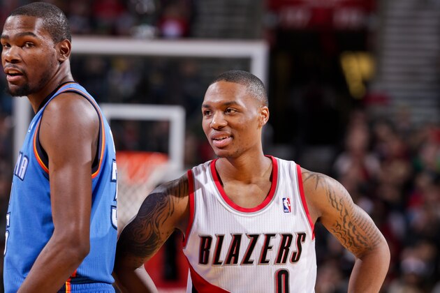 PORTLAND, OR - JANUARY 13: Damian Lillard #0 of the Portland Trail Blazers smiles while playing against Kevin Durant #35 of the Oklahoma City Thunder on January 13, 2013 at the Rose Garden Arena in Portland, Oregon. NOTE TO USER: User expressly acknowledges and agrees that, by downloading and or using this photograph, user is consenting to the terms and conditions of the Getty Images License Agreement. Mandatory Copyright Notice: Copyright 2013 NBAE (Photo by Sam Forencich/NBAE via Getty Images)