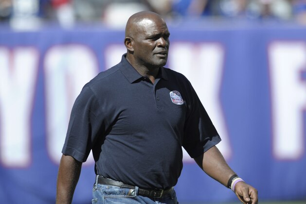 Former New York Giants' Lawrence Taylor walks onto the field during a 25 year anniversary celebration at halftime of an NFL football game against the Atlanta Falcons, Sunday, Sept. 20, 2015, in East Rutherford, N.J. (AP Photo/Bill Kostroun)