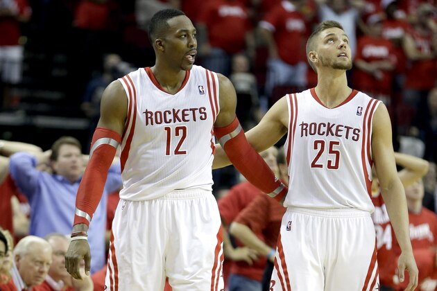 Houston Rockets' Chandler Parsons (25) puts his arm around Dwight Howard (12) after Howard fouled out of the game during overtime in Game 1 of an opening-round NBA basketball playoff series against the Portland Trail Blazers Sunday, April 20, 2014, in Houston. The Trail Blazers won 122-120 in overtime. (AP Photo/David J. Phillip)