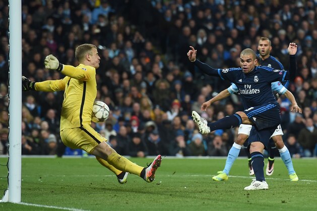 Manchester City's English goalkeeper Joe Hart (L) makes a save from Real Madrid's Portuguese defender Pepe (R) during the UEFA Champions League semi-final first leg football match between Manchester City and Real Madrid at the Etihad Stadium in Manchester, northwest England, on April 26, 2016. / AFP / PAUL ELLIS        (Photo credit should read PAUL ELLIS/AFP/Getty Images)