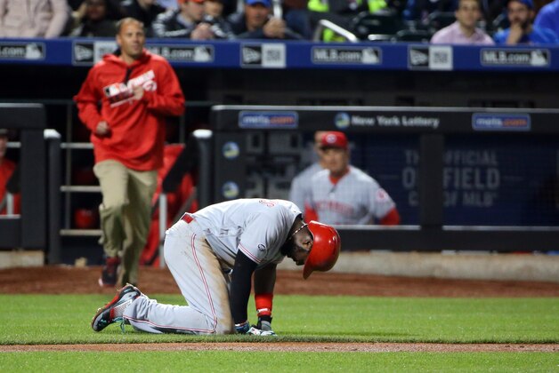 Apr 25, 2016; New York City, NY, USA;  Cincinnati Reds second baseman Brandon Phillips (4) falls to the ground after being hit by a pitch during the fourth inning against the New York Mets at Citi Field. Mandatory Credit: Anthony Gruppuso-USA TODAY Sports