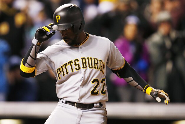 Pittsburgh Pirates' Andrew McCutchen tips his helmet as he crosses home plate after hitting a three-run home run off Colorado Rockies relief pitcher Christian Bergman in the sixth inning of a baseball game Tuesday, April 26, 2016, in Denver. (AP Photo/David Zalubowski)