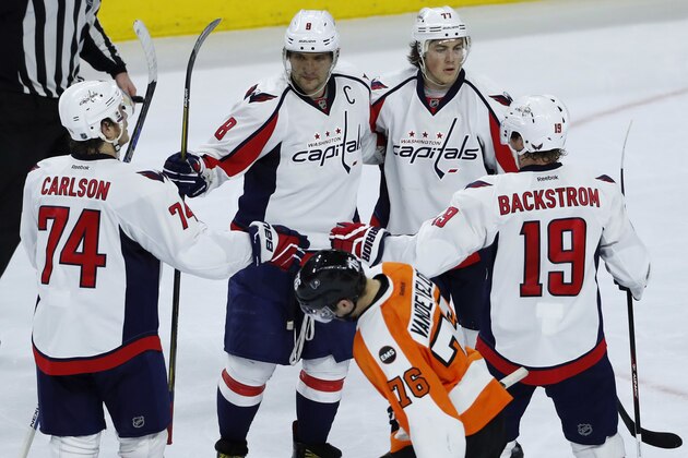 Washington Capitals' John Carlson (74), Alex Ovechkin (8) T.J. Oshie (77) and Nicklas Backstrom (19) celebrate as they stand by Philadelphia Flyers' Chris VandeVelde (76) after Ovechkin's goal during the third period of Game 3 in the first round of the NHL Stanley Cup hockey playoffs, Monday, April 18, 2016, in Philadelphia. Washington won 6-1. (AP Photo/Matt Slocum)
