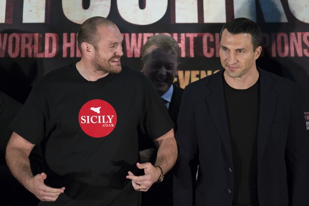 Britain's Tyson Fury, left, the heavyweight world boxing champion and Ukrainian Wladimir Klitschko, attend a press conference in Manchester, England, Wednesday, April 27, 2016.  The two boxers are scheduled for a rematch on Saturday July 9 at the Manchester Arena. (AP Photo/Jon Super)