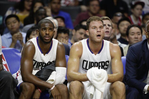 FILE - In this Oct. 20, 2015 file photo, Los Angeles Clippers' Chris Paul, left, and Blake Griffin watch from the bench during the first half of an NBA preseason basketball game against the Golden State Warriors, in Los Angeles. Without injured stars Chris Paul and Blake Griffin, the banged-up Los Angeles Clippers try to take a 3-2 lead over the Portland Trail Blazers in Game 5 of their first-round series, Wednesday, April 27, 2016. (AP Photo/Jae C. Hong, File)