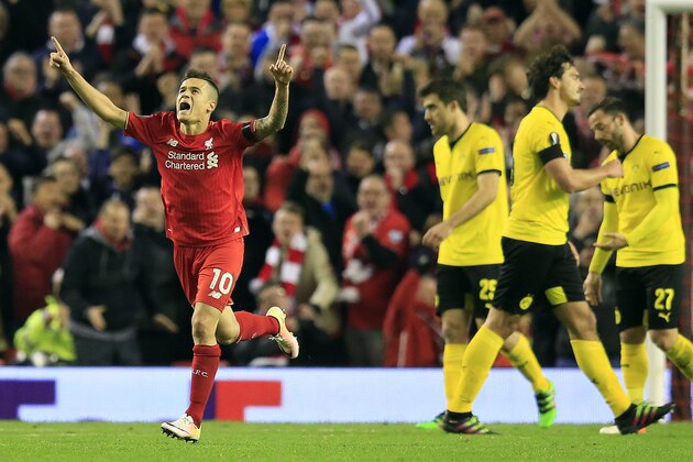 Liverpool's Philippe Coutinho, left, celebrates after scoring during the Europa League quarterfinal second leg soccer match between Liverpool  FC and Borussia Dortmund in Liverpool, England, Thursday, April 14, 2016 . (AP Photo/Jon Super)
