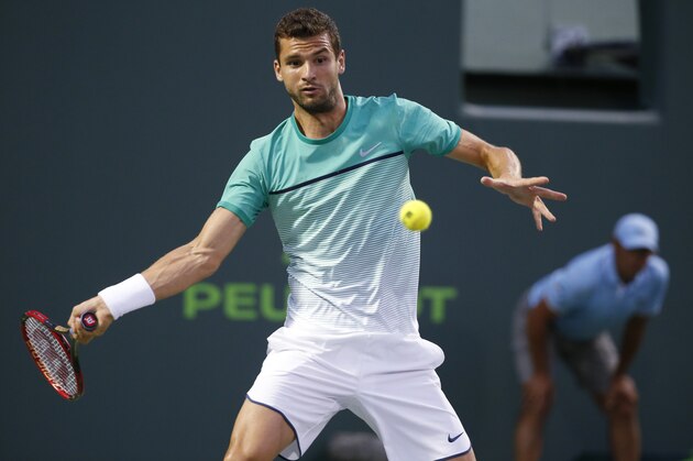 Grigor Dimitrov, of Bulgaria, returns a shot from Gael Monfils, of France, at the Miami Open tennis tournament, Tuesday, March 29, 2016, in Key Biscayne, Fla. (AP Photo/Wilfredo Lee)