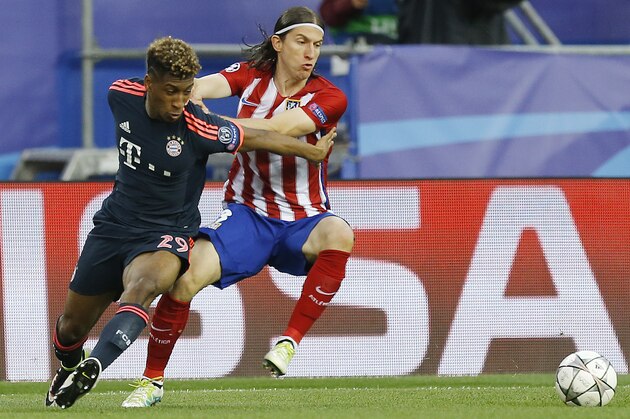Atletico's Filipe Luis, right, and Bayern’s Kingsley Coman challenge for the ball during the Champions League 1st leg semifinal soccer match between Atletico Madrid and Bayern Munich at the Vicente Calderon stadium in Madrid, Spain, Wednesday, April 27, 2016. (AP Photo/Francisco Seco)