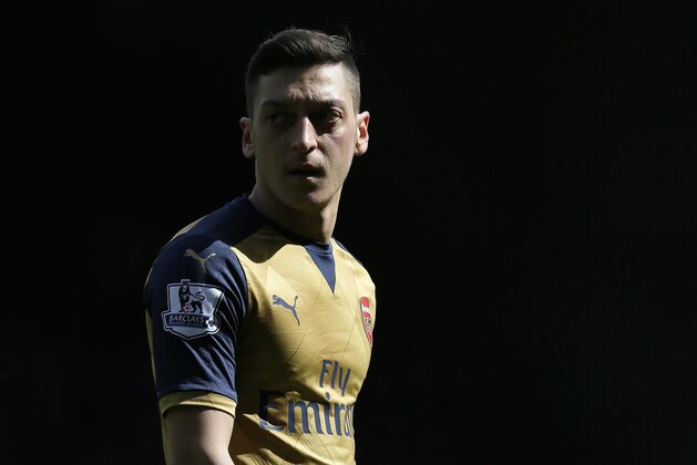 Arsenal's Mesut Ozil looks across the pitch during the English Premier League soccer match between West Ham United and Arsenal at Upton Park stadium in London, Saturday April 9, 2016. (AP Photo/Tim Ireland)