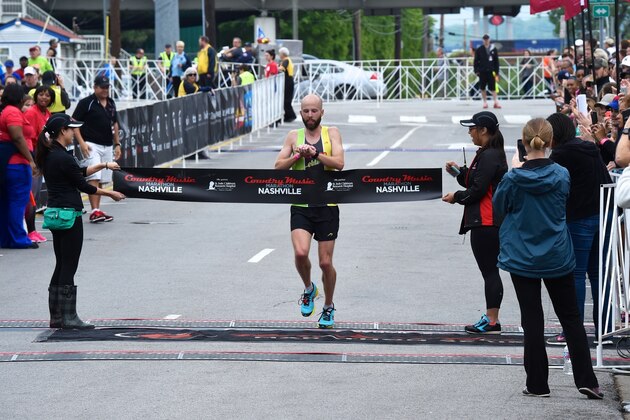NASHVILLE, TN - APRIL 25:  Runner Scott Wietecha crosses the finish line first at St. Jude Country Music Marathon & Half Marathon on April 25, 2015 in Nashville, Tennessee.  (Photo by Rick Diamond/Getty Images for St. Jude)