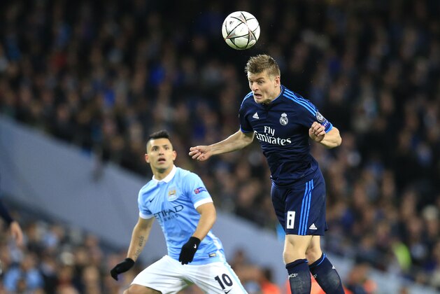 Real Madrid's Toni Kroos jumps for the ball next to Manchester City's Sergio Aguero during the Champions League semifinal soccer match between Manchester City and Real Madrid, at the City of Manchester stadium in Manchester, England, Tuesday, April 26, 2016. (AP Photo/Jon Super)