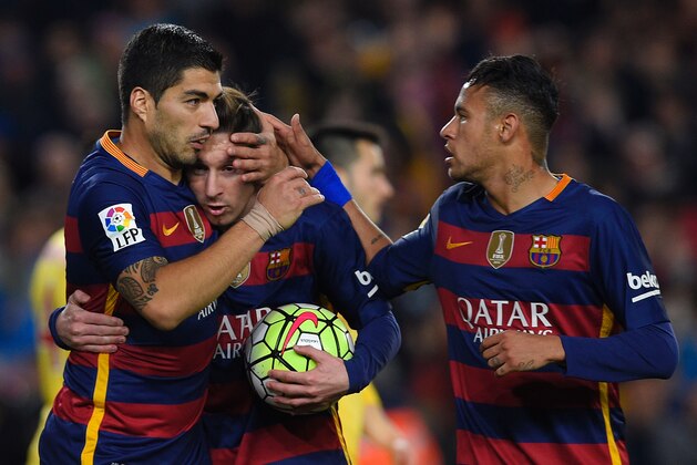 Barcelona's Uruguayan forward Luis Suarez (L) celebrates with Barcelona's Argentinian forward Lionel Messi (C) and Barcelona's Brazilian forward Neymar after scoring during the Spanish league football match FC Barcelona vs Real Sporting de Gijï¿½ï¿½ï¿½ï¿½ï¿½ï¿½n at the Camp Nou stadium in Barcelona on April 23, 2016. / AFP / LLUIS GENE        (Photo credit should read LLUIS GENE/AFP/Getty Images)
