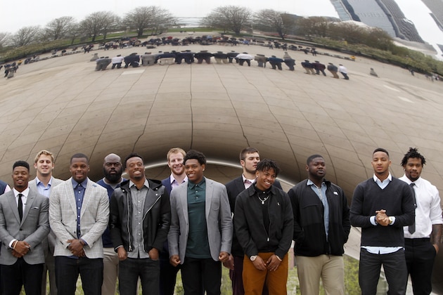 2016 NFL football draft prospects gather around Annish Kapoor's stainless steel Cloud Gate sculpture, also known as