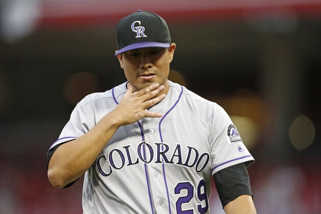 Colorado Rockies starting pitcher Jorge De La Rosa (29) reacts as he walks to the dugout after giving up four runs to the Cincinnati Reds during the second inning of a baseball game, Tuesday, April 19, 2016, in Cincinnati. (AP Photo/Gary Landers)