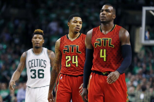 Atlanta Hawks' Kent Bazemore (24) and Paul Millsap (4) walk up court in front of Boston Celtics' Marcus Smart (36) in overtime during game 4 of a first-round NBA basketball playoff series in Boston, Sunday, April, 24, 2016. The Celtics won 104-95. (AP Photo/Michael Dwyer)