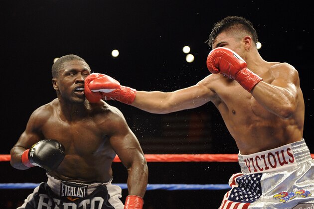 Andre Berto, left, and Victor Ortiz trade punches during the third round of their WBC World Welterweight Championship fight in Uncasville, Conn., on Saturday, April 16, 2011. Ortiz won the fight in a unanimous decision. (AP Photo/Fred Beckham)