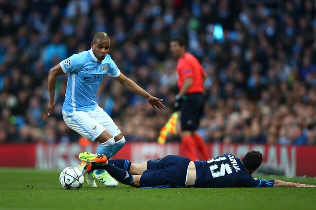 MANCHESTER, ENGLAND - APRIL 26:  Fernando of Manchester City goes apst the challenge from Daniel Carvajal of Real Madrid CF during the UEFA Champions League Semi Final first leg match between Manchester City FC and Real Madrid at the Etihad Stadium on April 26, 2016 in Manchester, United Kingdom.  (Photo by Paul Gilham/Getty Images)