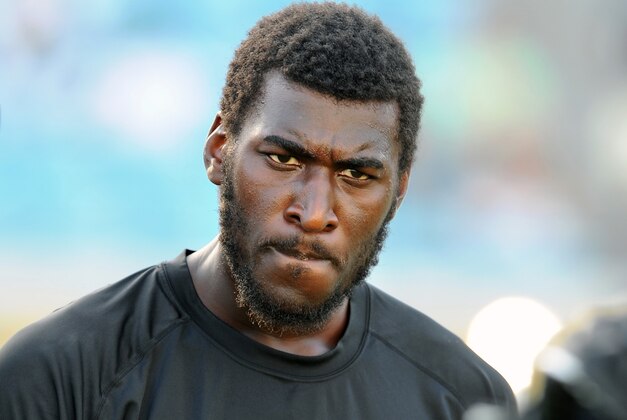 FILE - In this Aug. 9, 2013 file photo, Jacksonville Jaguars wide receiver Justin Blackmon speaks with a teammate during warmups before an NFL preseason football game against the Miami Dolphins, in Jacksonville, Fla. Blackmon was suspended for the rest of the season Friday, Nov. 1, 2013, for another violation of the NFL's substance-abuse policy.  (AP Photo/Stephen Morton, File)