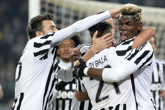 Juventus' Paulo Dybala celebrates with his teammates Paul Pogba, right, and Andrea Barzagli, left, after scoring during a Serie A soccer match, at the Juventus stadium, in Turin, Italy, Sunday, Jan. 24, 2016. Juventus won 1-0. (AP Photo/Massimo Pinca)