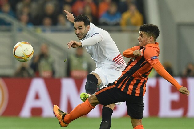 Taison (R) of FC Shakhtar vies for a ball with Adil Rami (L) of Sevilla FC during the UEFA Europa League semi-final football match FC Shakhtar Donetsk vs  Sevilla FC at the Arena Lviv stadium in Lviv on April 28, 2016. / AFP / GENYA SAVILOV        (Photo credit should read GENYA SAVILOV/AFP/Getty Images)