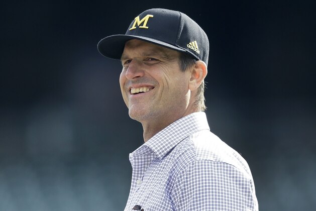 University of Michigan head football coach Jim Harbaugh watches batting practice before a baseball game between the Detroit Tigers and the Oakland Athletics, Wednesday, April 27, 2016, in Detroit. (AP Photo/Carlos Osorio)