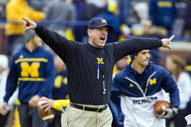 Michigan head coach Jim Harbaugh shouts instructions to his players on the Michigan Stadium field during warmups before an NCAA college football game against Michigan State in Ann Arbor, Mich., Saturday, Oct. 17, 2015. (AP Photo/Tony Ding)