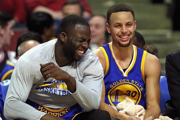 CHICAGO, IL - JANUARY 20:  Draymond Green #23 (L) and Stephen Curry #30 of the Golden State Warriors share a laugh on the bench near the end of a game against the Chicago Bulls at the United Center on January 20, 2016 in Chicago, Illinois. The Warriors defeated the Bulls 125-94. NOTE TO USER: User expressly acknowledges and agrees that, by downloading and or using the photograph, User is consenting to the terms and conditions of the Getty Images License Agreement.  (Photo by Jonathan Daniel/Getty Images)