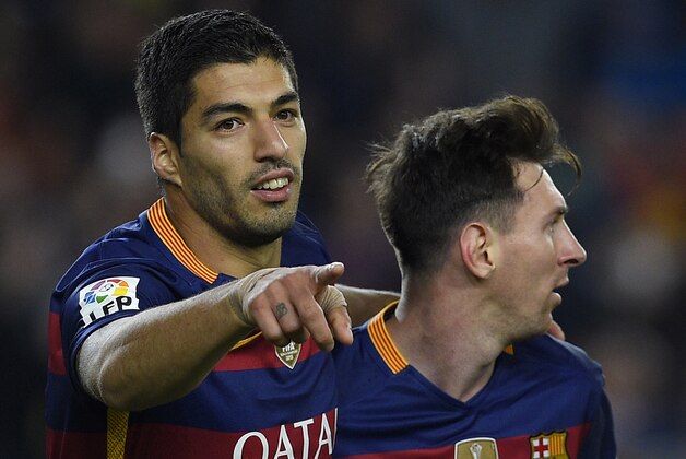 Barcelona's Uruguayan forward Luis Suarez (L) celebrates with Barcelona's Argentinian forward Lionel Messi after scoring during the Spanish league football match FC Barcelona vs Real Sporting de Gijï¿½ï¿½ï¿½ï¿½ï¿½ï¿½n at the Camp Nou stadium in Barcelona on April 23, 2016. / AFP / LLUIS GENE        (Photo credit should read LLUIS GENE/AFP/Getty Images)
