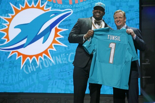 Mississippi’s Laremy Tunsil poses for photos with NFL commissioner Roger Goodell after being selected by the Miami Dolphins as the 13th pick in the first round of the 2016 NFL football draft, Thursday, April 28, 2016, in Chicago. (AP Photo/Charles Rex Arbogast)