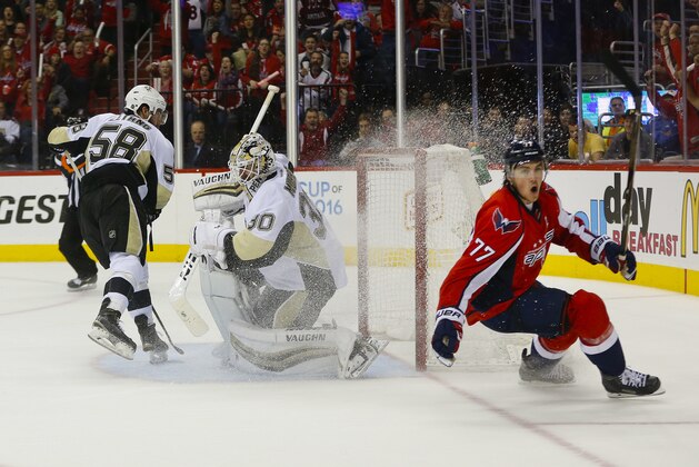 Washington Capitals right wing T.J. Oshie (77) starts to celebrate his goal against Pittsburgh Penguins goalie Matt Murray (30) and Kris Letang (58) during the second period of Game 1 in an NHL hockey Stanley Cup Eastern Conference semifinals Thursday, April 28, 2016 in Washington. (AP Photo/Pablo Martinez Monsivais)