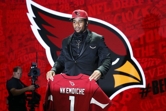 Mississippi’s Robert Nkemdiche poses for photos after being selected by the Arizona Cardinals as the 29th pick in the first round of the 2016 NFL football draft, Thursday, April 28, 2016, in Chicago. (AP Photo/Charles Rex Arbogast)