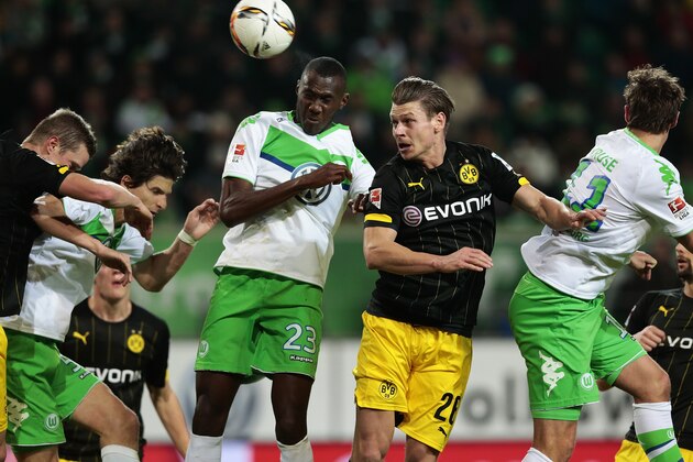WOLFSBURG, GERMANY - DECEMBER 05: Josuha Guilavogui (L) of Wolfsburg and Lukasz Piszczek (R) of Dortmund compete for the ball during the First Bundesliga match at between VfL Wolfsburg and Borussia Dortmund at Volkswagen Arena on December 5, 2015 in Wolfsburg, Germany.  (Photo by Oliver Hardt/Getty Images For MAN)