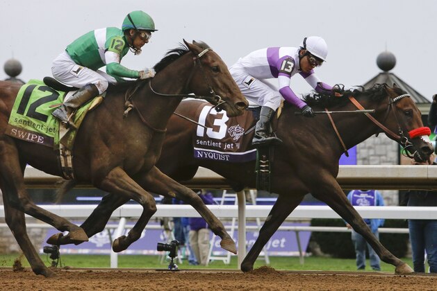 Nyquist (13), with Mario Gutierrez up, wins the Breeders' Cup Juvenile horse race at Keeneland race track Saturday, Oct. 31, 2015, in Lexington, Ky. Swipe (12), with Victor Espinoza up, finished second. (AP Photo/Garry Jones)
