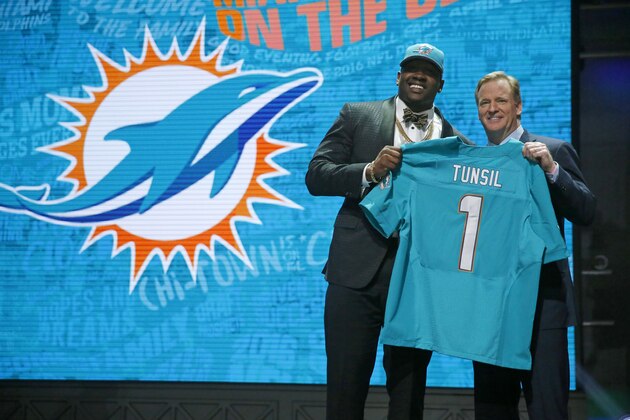 Mississippi’s Laremy Tunsil poses for photos with NFL commissioner Roger Goodell after being selected by the Miami Dolphins as the 13th pick in the first round of the 2016 NFL football draft, Thursday, April 28, 2016, in Chicago. (AP Photo/Charles Rex Arbogast)