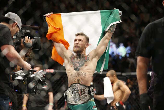Conor McGregor reacts after defeating Jose Aldo during a featherweight  championship mixed martial arts bout at UFC 194, Saturday, Dec. 12, 2015, in Las Vegas. (AP Photo/John Locher)