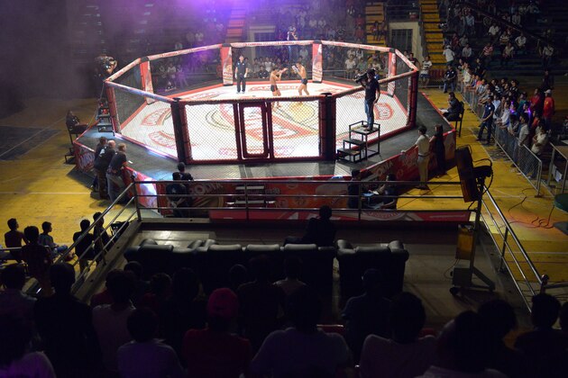 TO GO WITH AFP STORY: Cambodia-lifestyle-sport-MMA,FEATURE by Suy SE
This photo taken on August 24, 2014 shows a general view of a Cambodian cage fight for a local television (TV) programme at a statium in Phnom Penh. He is schooled in ancient Cambodian martial arts, but Tok Sophon hopes to turn his pugilism skills into wealth and international glory in the modern cage-fighting arena -- a transition some fighters fear will wipe out their craft.     AFP PHOTO/TANG CHHIN SOTHY        (Photo credit should read TANG CHHIN SOTHY/AFP/Getty Images)